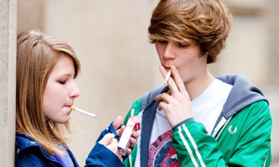 Teen smokes cigarette then sticks