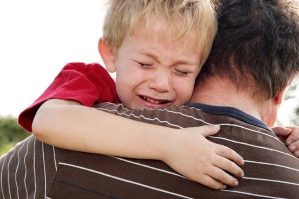 Мальчик на руках у папы плачет