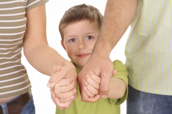 Ребенок держит родителей за руки