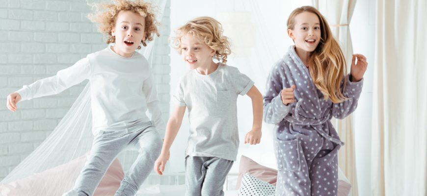 Children jumping on the bed